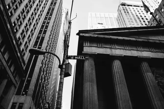 a photo of a street sign from wall street