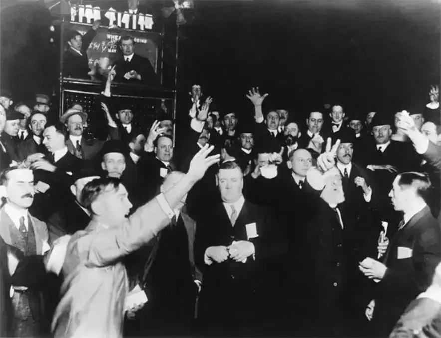 A group of men in an old photo, several are raising their arms
